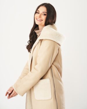 Kożuch damski w jasnym odcieniu beżu z kapturem i miękkim futrzanym wykończeniem, z kieszeniami po bokach